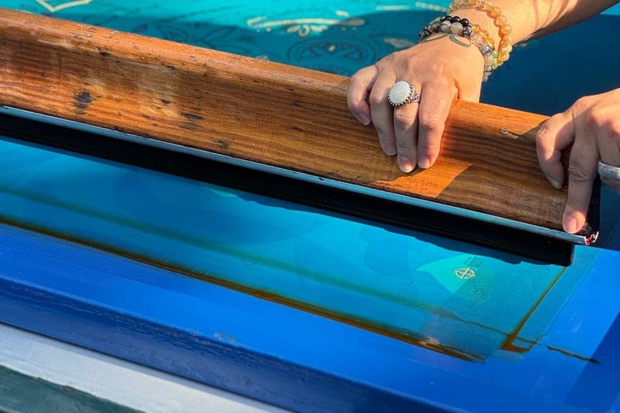 Screen printing a design onto fabric by hand