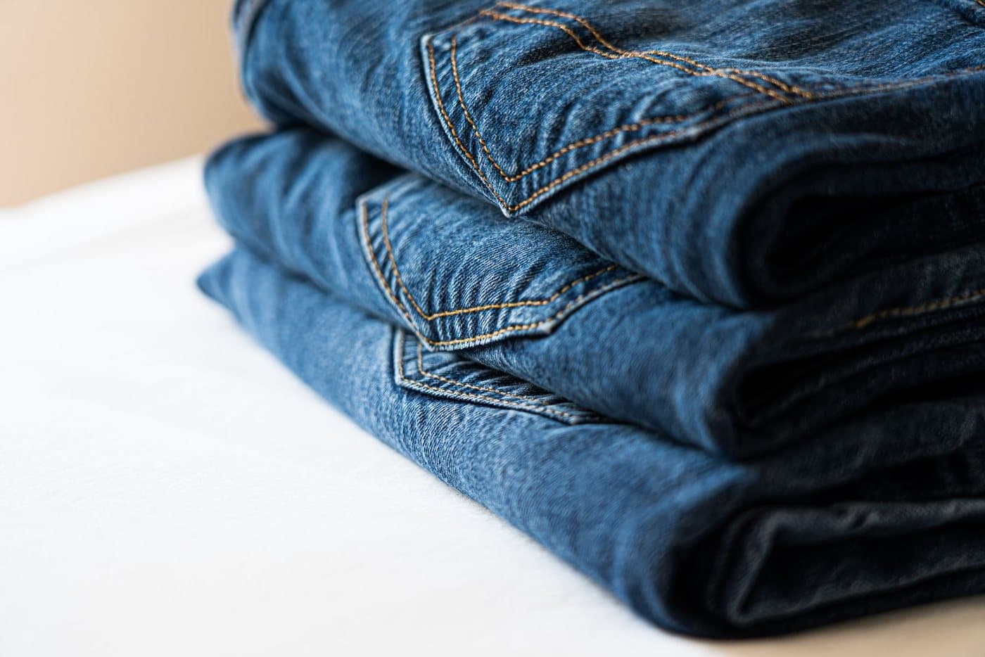 Folded blue denim jeans stacked